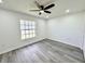 Bedroom with vinyl floors and a window overlooking the backyard at 1390 Patricia St, Kissimmee, FL 34744