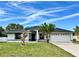 Charming single-story home featuring a well-manicured lawn and attached two-car garage at 1390 Patricia St, Kissimmee, FL 34744