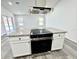 Modern kitchen features a large island with granite countertops and stainless steel appliances at 1390 Patricia St, Kissimmee, FL 34744
