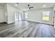 Bright living room with vaulted ceilings, neutral walls, and sliding glass doors leading to the pool at 1390 Patricia St, Kissimmee, FL 34744