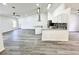 Spacious living area featuring wood-look floors and a seamless flow to the kitchen at 1390 Patricia St, Kissimmee, FL 34744