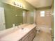 Well-maintained bathroom with a vanity, large mirror, and a shower-tub combination at 250 Ashley Rd, Mascotte, FL 34753