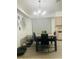 Dining area with modern lighting, table with chairs, and view of the backyard at 250 Ashley Rd, Mascotte, FL 34753