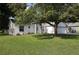 Inviting single-Gathering home with lush landscaping, large trees, and a spacious driveway at 250 Ashley Rd, Mascotte, FL 34753