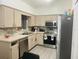 Functional kitchen with stainless steel appliances, tile backsplash, and ample counter space at 250 Ashley Rd, Mascotte, FL 34753
