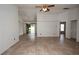 Open-concept living room with tile flooring, ceiling fan, and access to the backyard at 250 Ashley Rd, Mascotte, FL 34753