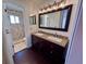 Well-lit bathroom featuring a double vanity and a tiled shower at 105 Ingram Cir, Longwood, FL 32779