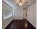 Bedroom featuring hardwood floors, ceiling fan, window, and closet with doors at 105 Ingram Cir, Longwood, FL 32779