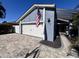 Wide driveway leading to a 2-car garage with a beautiful blue exterior and an American flag at 105 Ingram Cir, Longwood, FL 32779