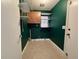 Laundry room with shelves, window, and green walls at 105 Ingram Cir, Longwood, FL 32779