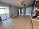 Bright living room with tile flooring, sliding glass doors, and a contemporary accent wall at 105 Ingram Cir, Longwood, FL 32779