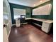 Home office with desk, shelving, storage, and dark-stained hardwood floors at 105 Ingram Cir, Longwood, FL 32779