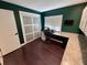 Home office with desk, shelving, storage, and dark-stained hardwood floors at 105 Ingram Cir, Longwood, FL 32779