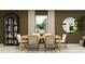 Dining area featuring a wooden table with chairs and a decorative mirror and shelving at 1807 Teagan Ln, Winter Haven, FL 33884