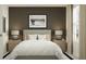 Inviting bedroom featuring a gray upholstered bed, white linens, bedside tables with lamps, and modern skateboard art at 1934 Sarah St, Winter Haven, FL 33884