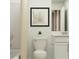 Well-lit bathroom featuring a toilet, shower-bathtub combo with shower curtain, and a vanity with a sink at 1950 Sarah St, Winter Haven, FL 33884