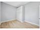 Bright bedroom featuring closet, neutral walls, and light hardwood flooring at 215 Maple Ln, Fort Meade, FL 33841