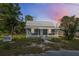 Charming single Gathering home at twilight featuring a welcoming front porch at 215 Maple Ln, Fort Meade, FL 33841