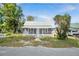 Charming single Gathering home featuring a welcoming front porch and mature trees at 215 Maple Ln, Fort Meade, FL 33841