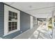 Inviting covered porch featuring white columns and painted floor at 215 Maple Ln, Fort Meade, FL 33841
