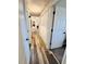 Hallway featuring wood-look flooring and access to multiple rooms at 228 Babson Dr, Babson Park, FL 33827