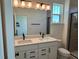 Bathroom featuring double sinks, quartz countertops, and modern fixtures at 15088 Grove Lake Dr, Winter Garden, FL 34787