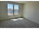 Bright bedroom with carpeted floors and view of the lake at 15088 Grove Lake Dr, Winter Garden, FL 34787