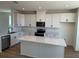 Modern kitchen with sleek white cabinets, quartz countertops, and stainless steel appliances at 15088 Grove Lake Dr, Winter Garden, FL 34787