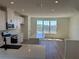 Bright and airy kitchen with quartz countertops, island, and view of the lake at 15088 Grove Lake Dr, Winter Garden, FL 34787