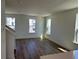 Open living room with hardwood floors, many large windows, and light walls at 15088 Grove Lake Dr, Winter Garden, FL 34787