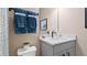 Modern bathroom featuring quartz countertops, decorative mirror, and ample lighting at 15113 Grove Lake Dr, Winter Garden, FL 34787