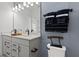 Modern bathroom features vanity with decorative hardware, quartz countertop, and ample lighting at 15113 Grove Lake Dr, Winter Garden, FL 34787