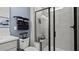 Modern bathroom features a beautiful shower with gray tile, shower bench, and black shower door at 15113 Grove Lake Dr, Winter Garden, FL 34787