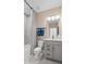 Modern bathroom featuring a shower-tub combo with gray tile, quartz countertop, and vanity at 15113 Grove Lake Dr, Winter Garden, FL 34787