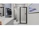 Modern bathroom features decorative vanity, gray tile, and shower with black hardware at 15113 Grove Lake Dr, Winter Garden, FL 34787