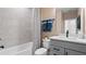 Modern bathroom featuring a shower-tub combo, quartz countertop, and vanity with modern hardware at 15113 Grove Lake Dr, Winter Garden, FL 34787