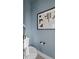 Cozy powder room showcasing blue walls, contemporary art, and a modern toilet at 15113 Grove Lake Dr, Winter Garden, FL 34787