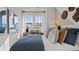 Bright bedroom featuring decor art, neutral walls, white curtains, and a large window with natural light at 15113 Grove Lake Dr, Winter Garden, FL 34787