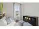 Unique bedroom featuring modern grey sofa, dog themed decor and a view from a bright window at 15113 Grove Lake Dr, Winter Garden, FL 34787