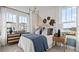 Bedroom featuring neutral walls with bright windows, contemporary decor and furniture, and comfortable bedding at 15113 Grove Lake Dr, Winter Garden, FL 34787