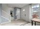 Bright foyer with stairs, large windows, tile floors, and white accents at 15113 Grove Lake Dr, Winter Garden, FL 34787