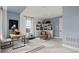 Stylish home office featuring a wooden desk, bookshelves, accent chair, and bright windows at 15113 Grove Lake Dr, Winter Garden, FL 34787