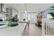 Bright open kitchen with white countertops, stainless appliances, and a breakfast bar overlooking the dining area at 15113 Grove Lake Dr, Winter Garden, FL 34787