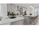 Modern kitchen featuring stainless steel appliances, white countertops, and a central island with bar seating at 15113 Grove Lake Dr, Winter Garden, FL 34787