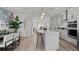 Open-concept kitchen featuring a large center island with seating and stainless steel appliances at 15113 Grove Lake Dr, Winter Garden, FL 34787