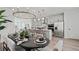Open-concept kitchen featuring stainless steel appliances, an island with bar seating, and a dining table at 15113 Grove Lake Dr, Winter Garden, FL 34787