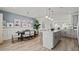 Contemporary kitchen with a large island, pendant lighting, and adjacent dining area at 15113 Grove Lake Dr, Winter Garden, FL 34787
