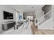 Open-concept living room with white walls, stairs, and an adjacent kitchen offering bright, airy spaces at 15113 Grove Lake Dr, Winter Garden, FL 34787