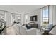 Bright and airy living room featuring a large sofa, modern decor, and ample natural light at 15113 Grove Lake Dr, Winter Garden, FL 34787