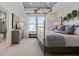 Cozy main bedroom with a chandelier, large windows, neutral tones, and an ensuite bathroom at 15113 Grove Lake Dr, Winter Garden, FL 34787
